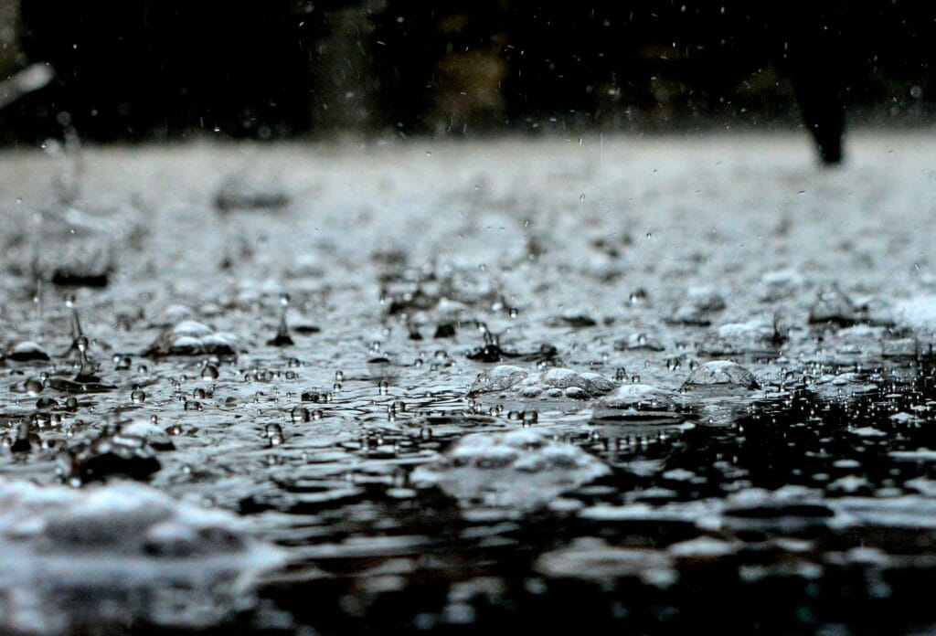 Detailed close-up of raindrops on a surface, capturing the essence of a heavy rain shower.